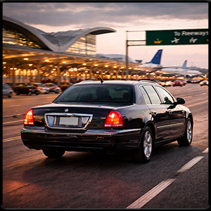 Dramatic shot of the town car driving away from the airport
